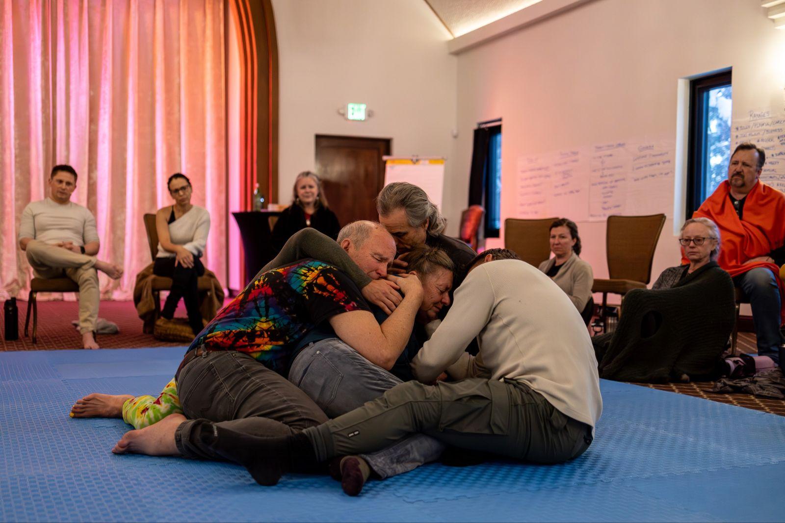 Several Heart iQ participants gathering closely around one person in the centre of the circle