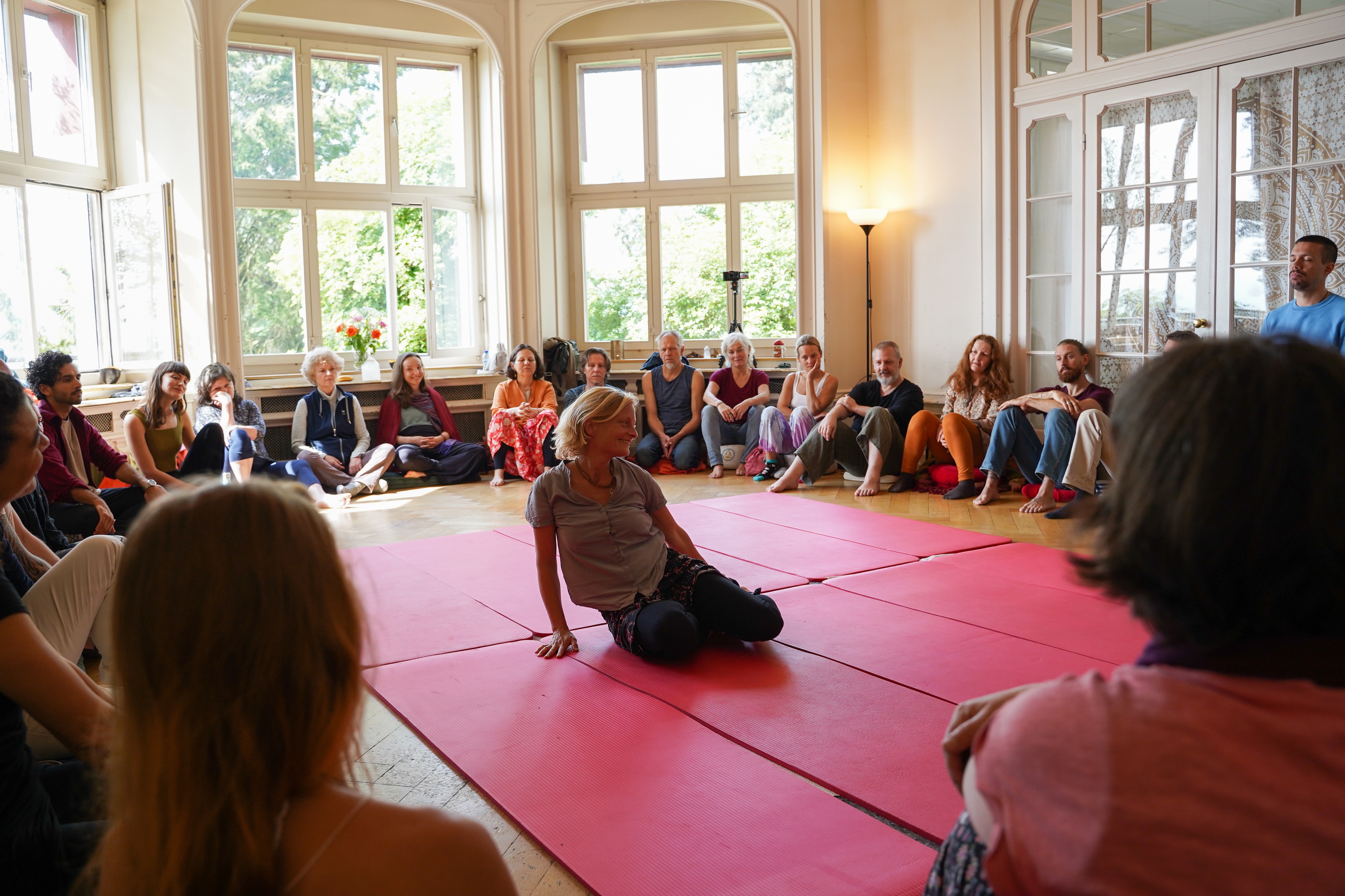 A participant practising while the original live group looks on